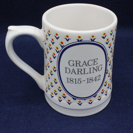 White mug with 'Grace Darling' text and decorative border on a dark blue background