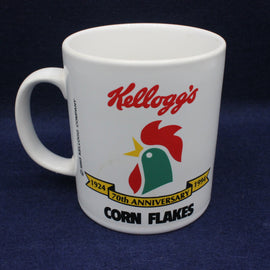 White mug with Kellogg's Corn Flakes logo on a dark blue background