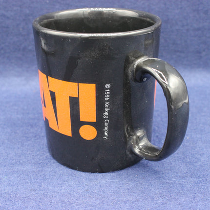 Black mug with orange text on a blue background