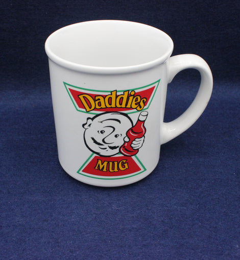 White mug with 'Daddies Mug' design on a blue background