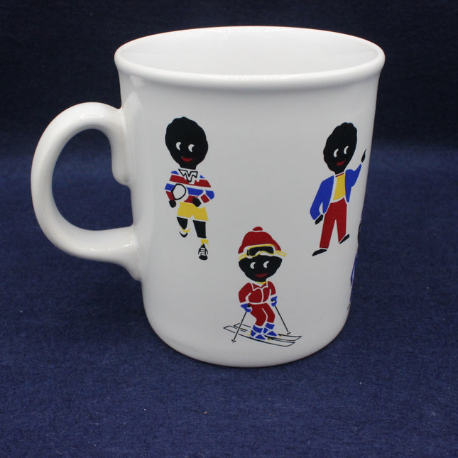 White mug with golly figures in colorful outfits on a dark blue background