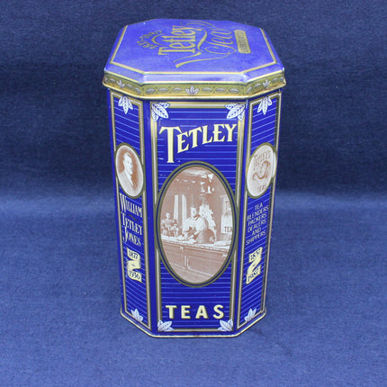 Blue and gold Tetley tea tin on a blue background