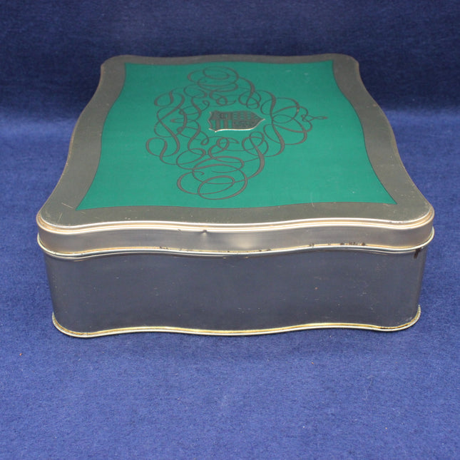 Decorative box with green top and black base on a blue background