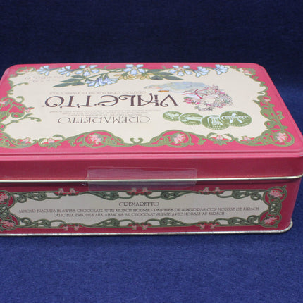 Decorative tin box with floral design on a blue background