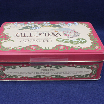 Decorative metal tin with floral design on a blue background