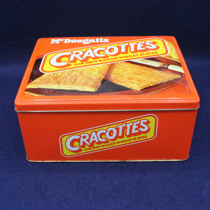 Red tin box of McDougall's Cracottes crackers on a blue background