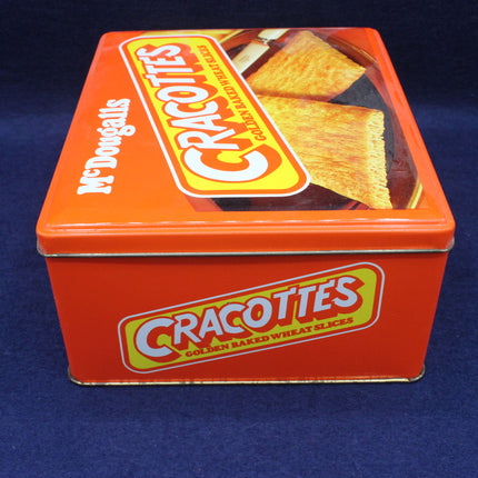 Orange tin box with Cracottes branding on a blue background