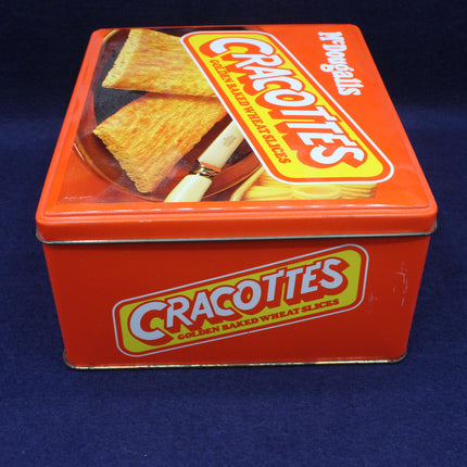 Red tin box with Cracottes branding on a blue background