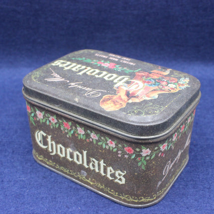 Decorative chocolate tin with floral designs on a blue background