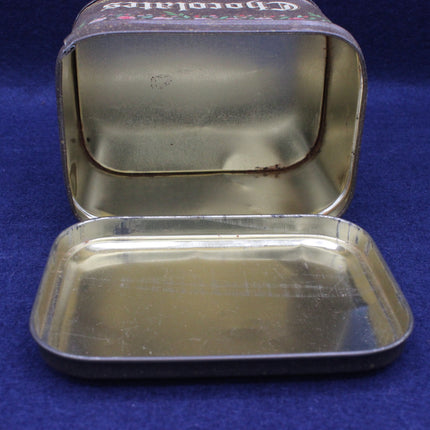 Open metal tin with a blue background