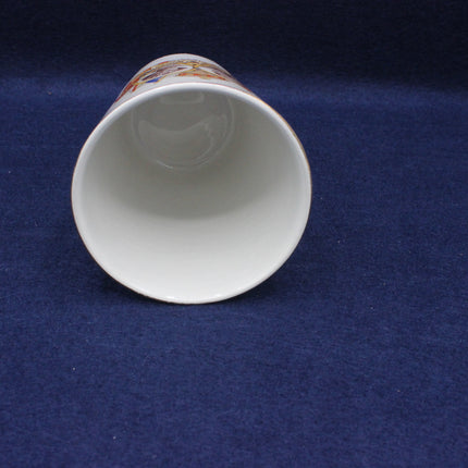 Ceramic cup with colorful design on a blue background