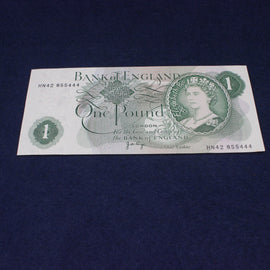 One pound banknote from the Bank of England on a dark blue background