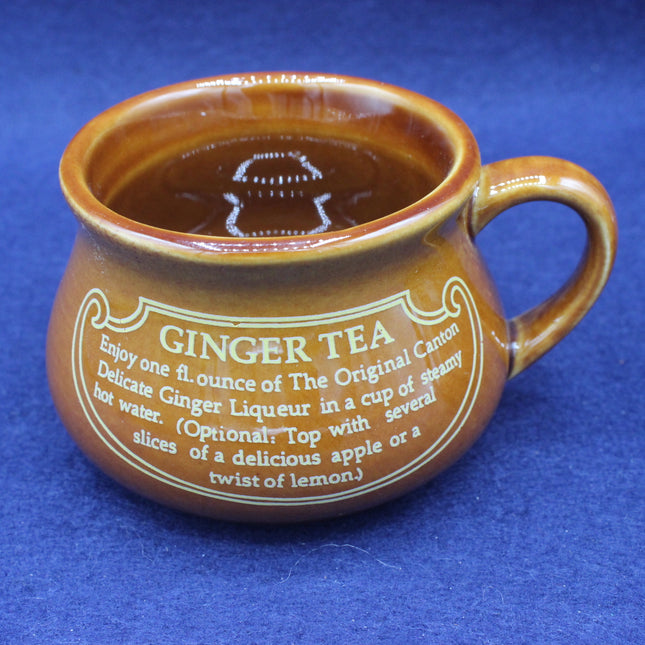 Brown ceramic mug with ginger tea text on a blue background