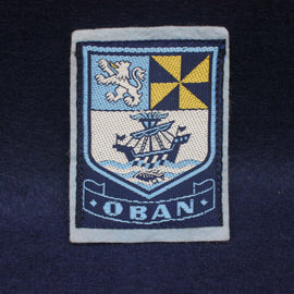 Embroidered patch with a crest and 'Oban' text on a dark background