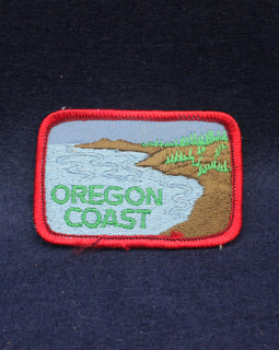 Embroidered patch of the Oregon Coast on a dark fabric background
