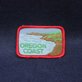 Embroidered patch of the Oregon Coast on a dark fabric background