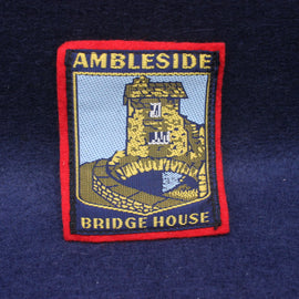Embroidered patch of Ambleside Bridge House on a dark blue fabric background