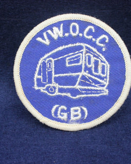 Circular patch with 'V.W.O.C.C.' and a caravan illustration on a blue background