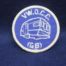 Circular patch with 'V.W.O.C.C.' and a caravan illustration on a blue background