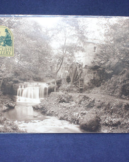 Black and white image of a waterfall and mill with 'Sutcliffe Gallery' logo.