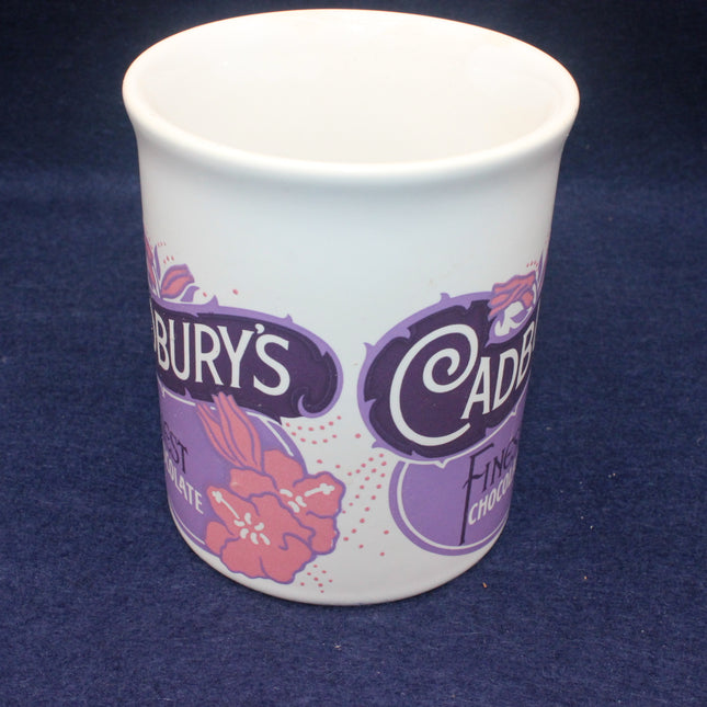 White mug with Cadbury branding on a dark blue background