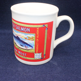 White mug with a red John West salmon label on a blue background