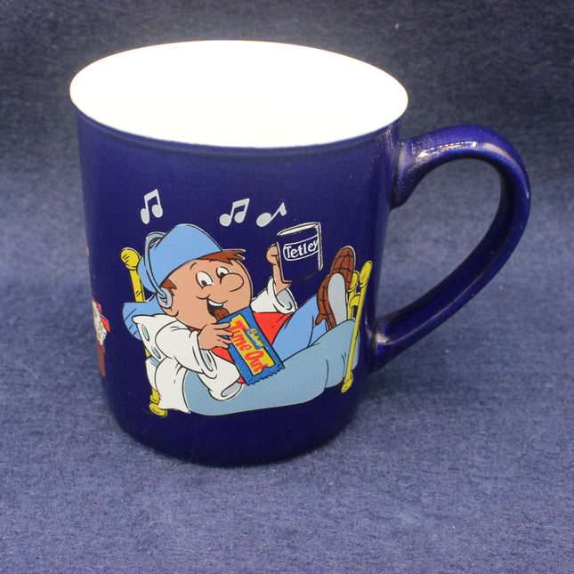 Blue mug with cartoon character holding a box on a dark blue background