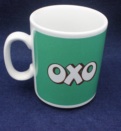 Green mug with 'OXO' logo on a blue background