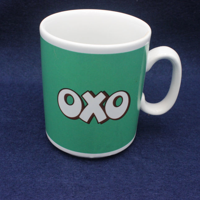 Green mug with 'OXO' logo on a blue background