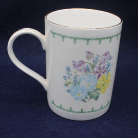 White mug with floral design on a dark blue background
