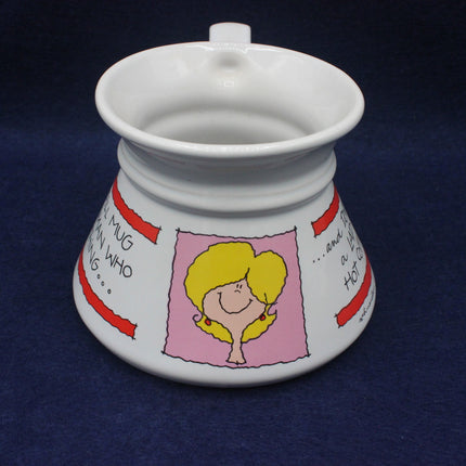 White ceramic mug with cartoon design on a dark blue background