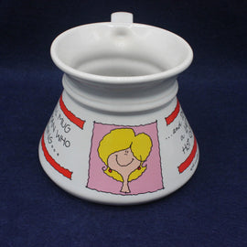 White ceramic mug with cartoon design on a dark blue background