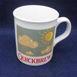 White mug with 'Quickbrew' design on a blue background
