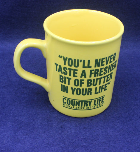 Yellow mug with green text on a blue background