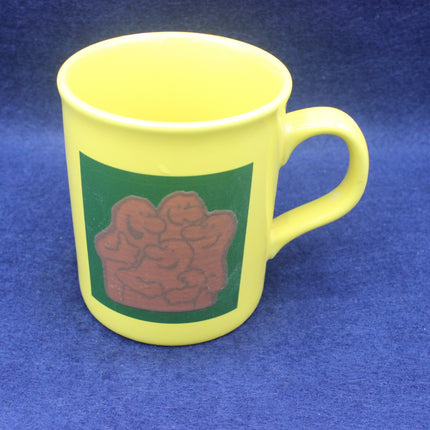 Yellow mug with a green and brown Country Life design on a blue background