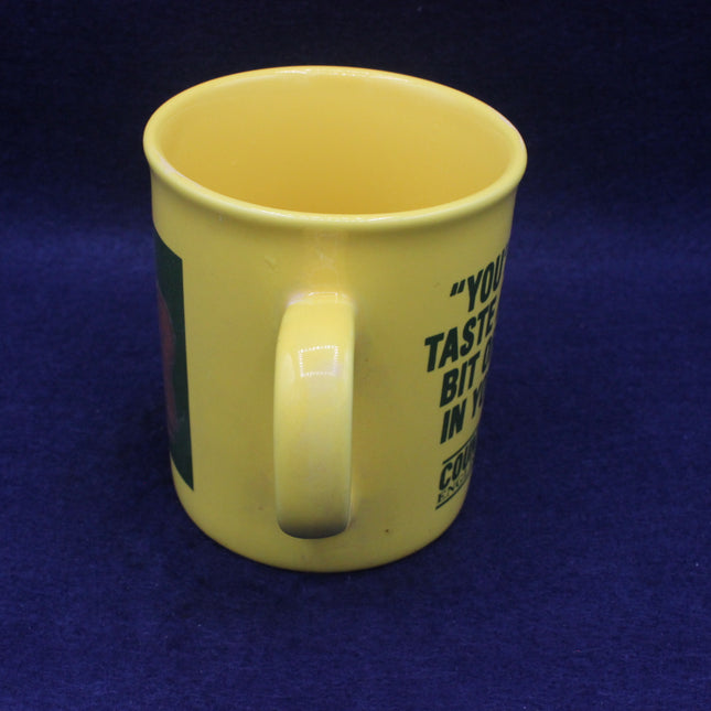 Yellow mug with text on a blue background