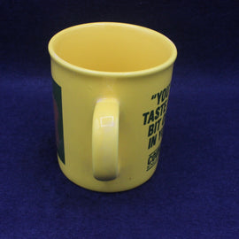 Yellow mug with text on a blue background