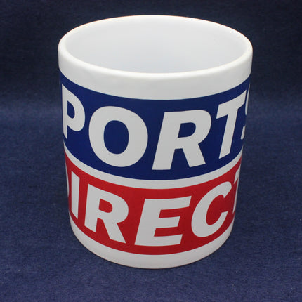 White mug with 'SPORTS DIRECT' text in red and blue on a dark blue background