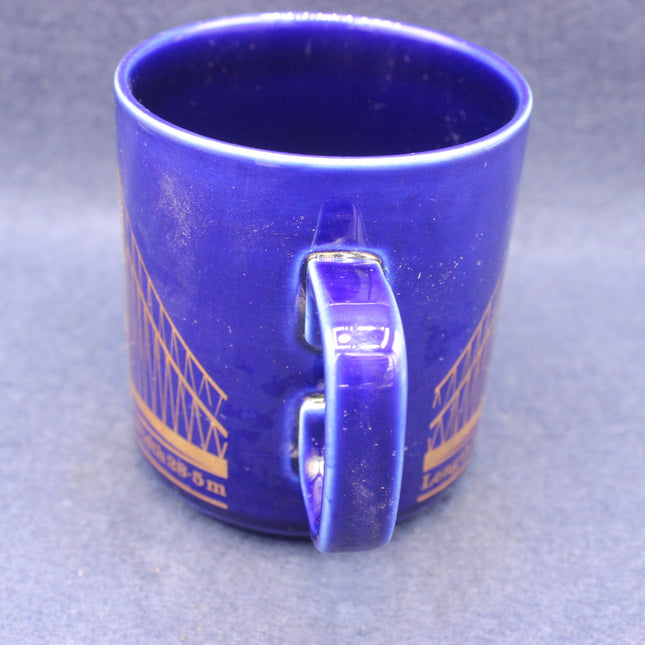 Blue mug with a handle on a gray background