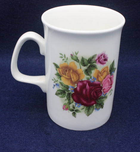 White mug with floral design on a blue background