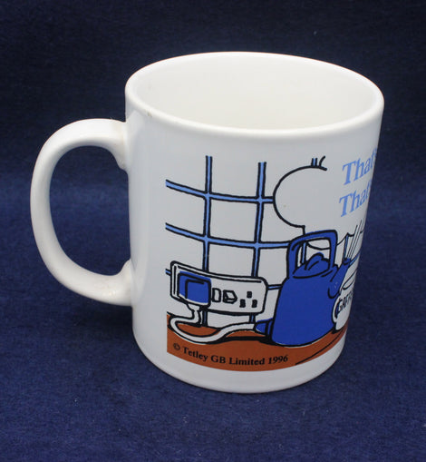 White mug with blue kettle design on a dark blue background