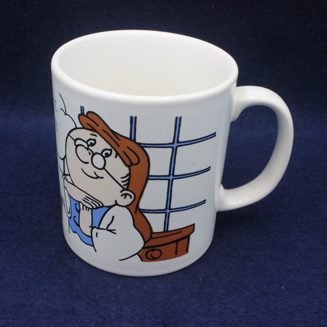 White mug with tetley tea folk character design on a dark blue background