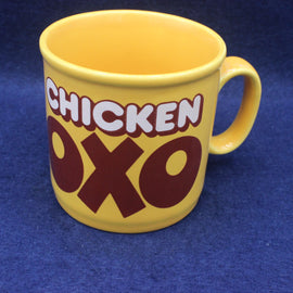 Yellow mug with 'CHICKEN OXO' text on a blue background