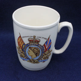 White mug with a royal crest and flags on a blue background