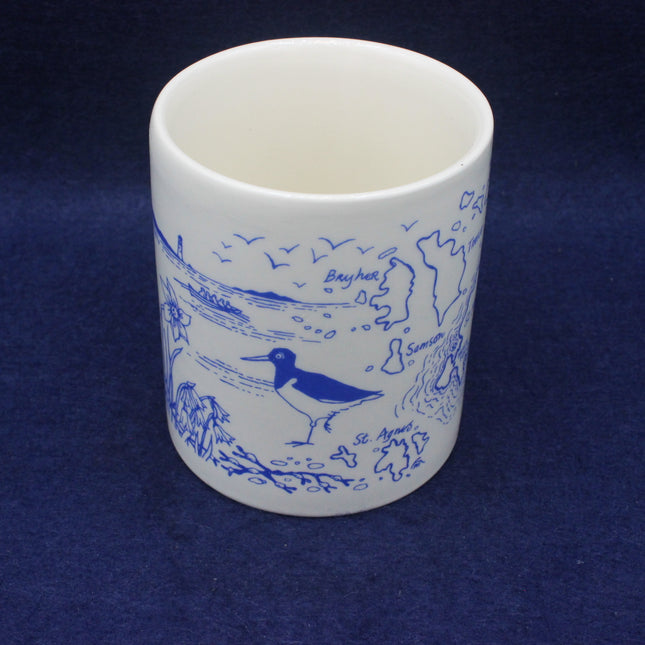 White ceramic mug with blue bird illustrations on a dark blue background