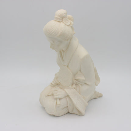 An off-white alabaster  figurine of a kneeling woman in traditional Japanese attire, captured against a seamless light gray studio background.