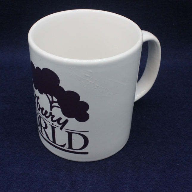 White mug with black text and design on a dark blue background