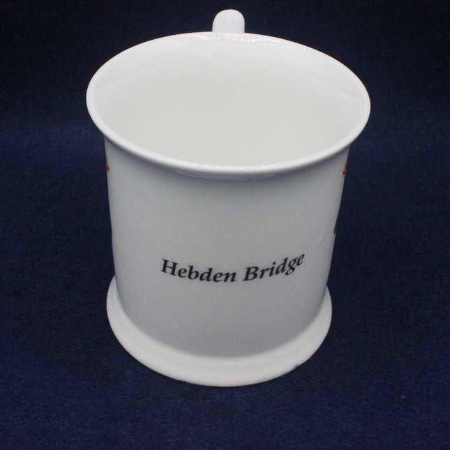 White ceramic mug with 'Hebden Bridge' text on a dark blue background