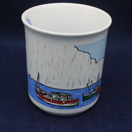 Ceramic mug with a scenic design of boats and mountains on a blue background