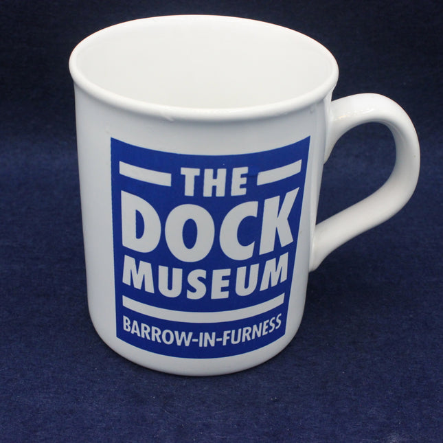 White mug with 'The Dock Museum Barrow-in-Furness' text on a blue background